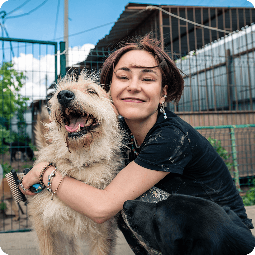 A pet owner hugging her dog