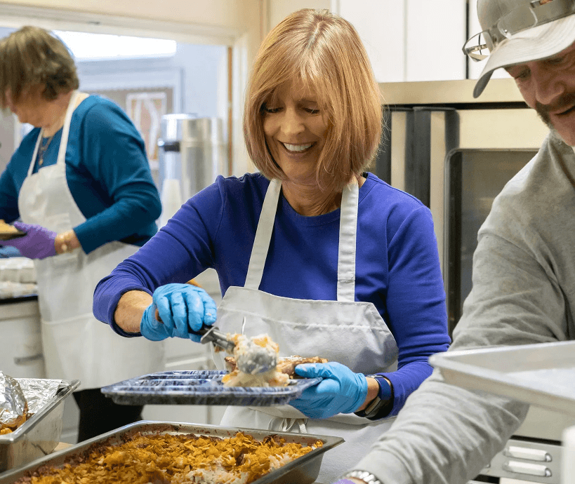Woman serving food at a charity event