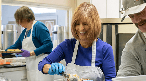Woman serving food at a charity event
