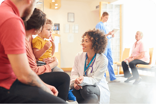 A smiling doctor talking to a family