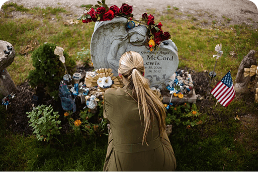 A person laying flowers on a grave