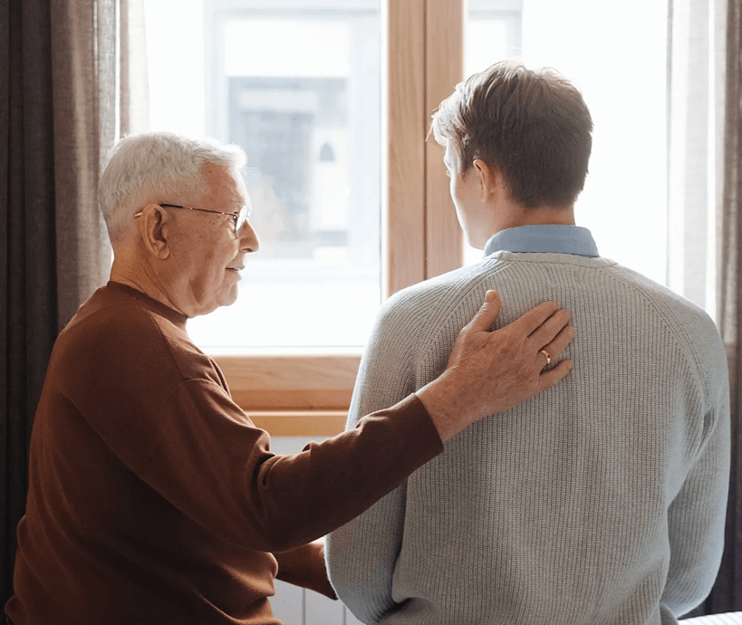 A grandfather consoling his grandson
